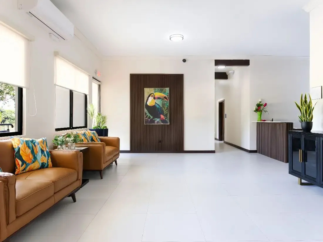 Bright lobby with leather seating and colorful artwork.