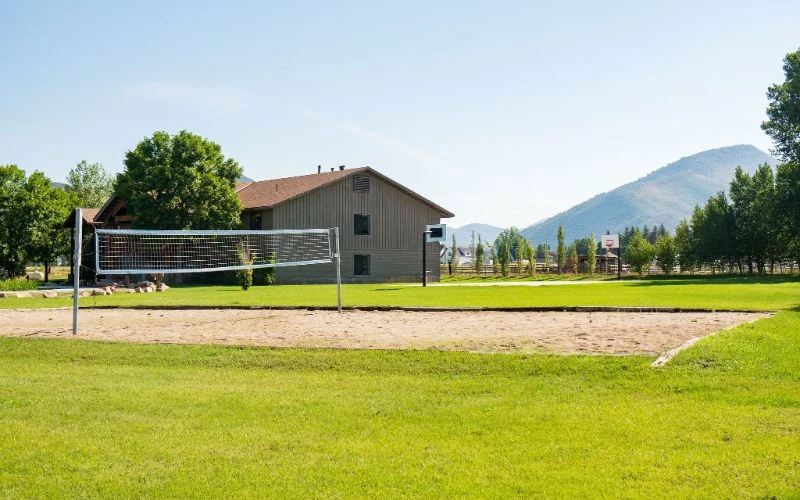 Sand volleyball court with grass and mountain view