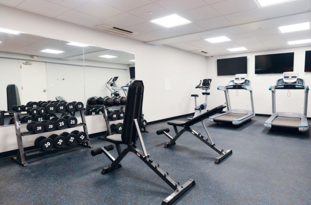 On-site gym with treadmills, weights, and exercise equipment