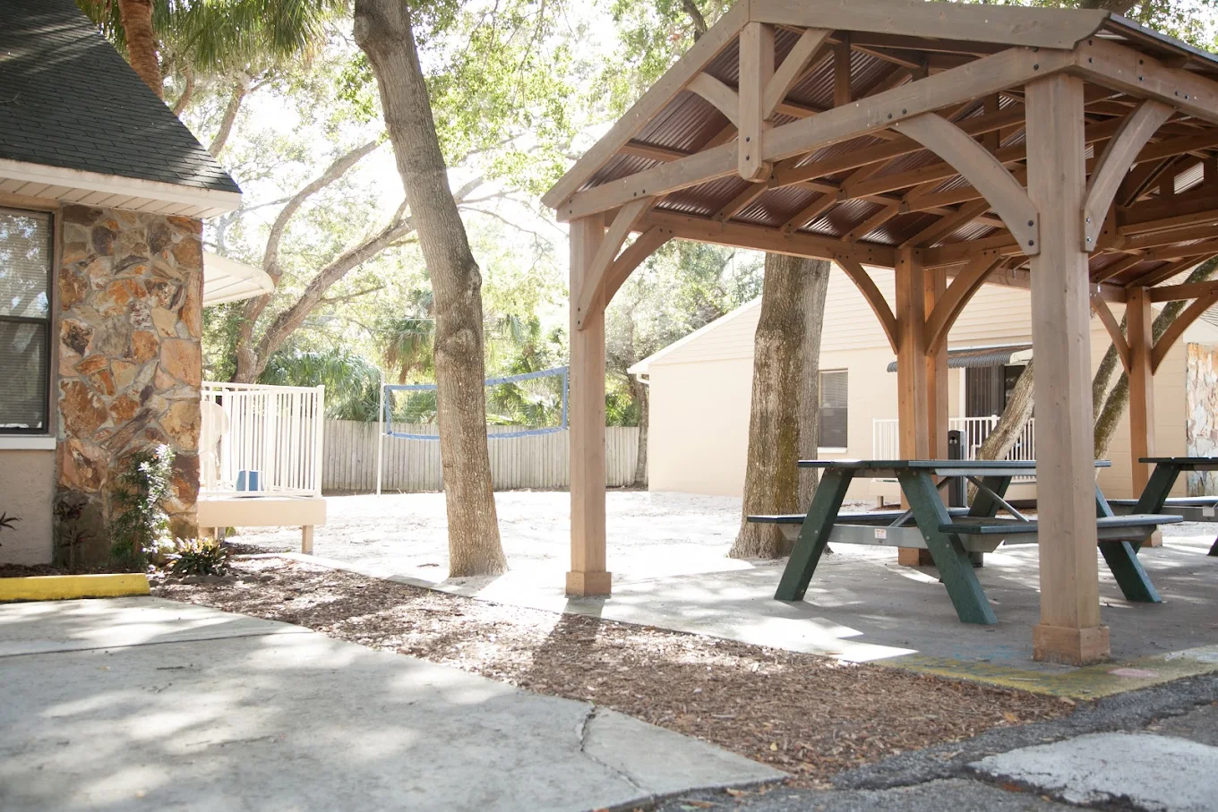 Covered outdoor picnic area with nearby trees