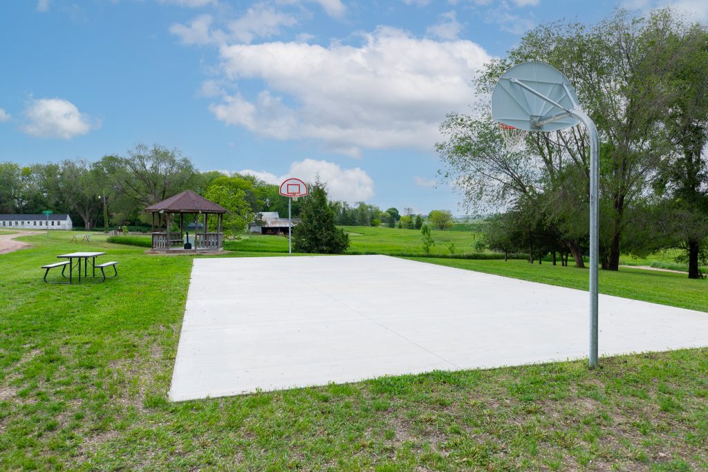 Outdoor basketball court beside a gazebo and picnic table
