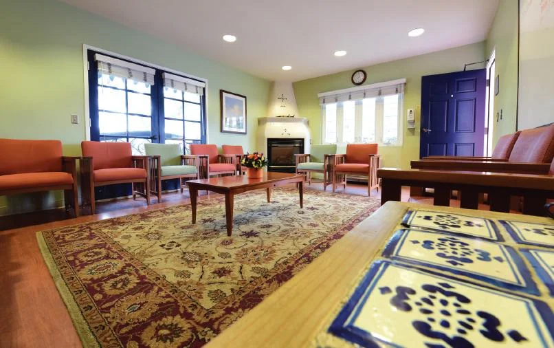 Bright lounge with chairs and fireplace for group therapy