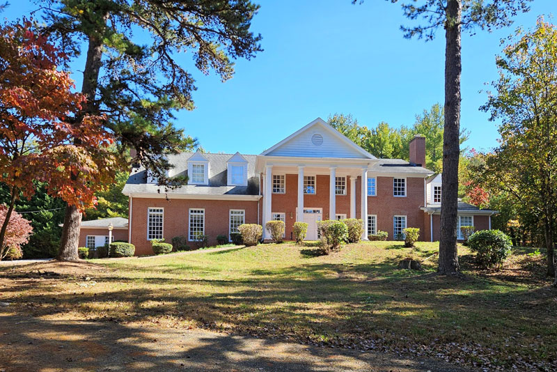 Red-brick two-story home with tall white columns