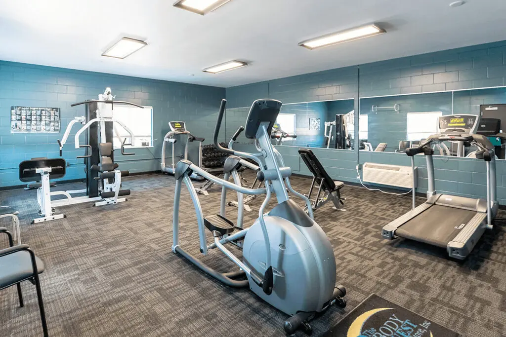 Gym with treadmills, weights, and exercise equipment