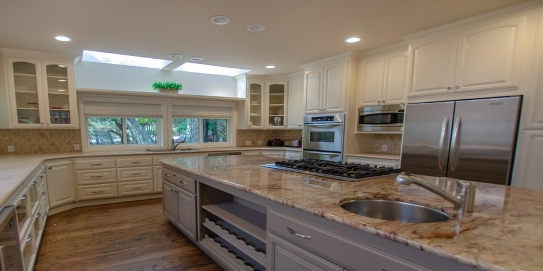Spacious modern kitchen with marble island and skylight