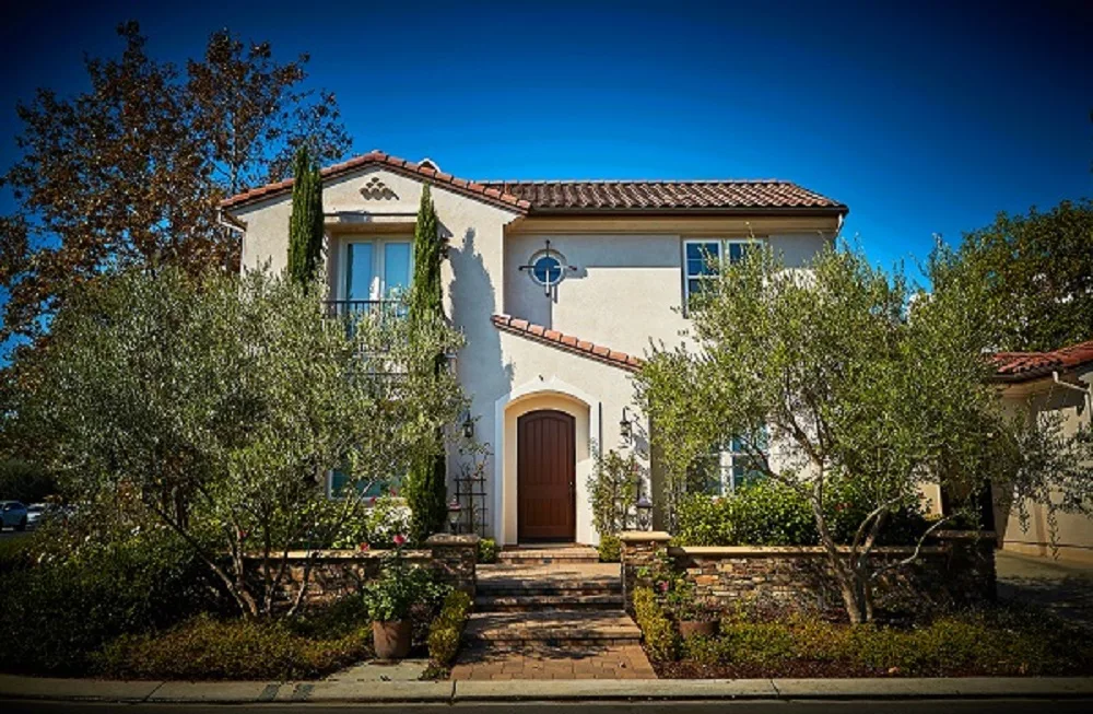 Front exterior of facility with arched entry and trees