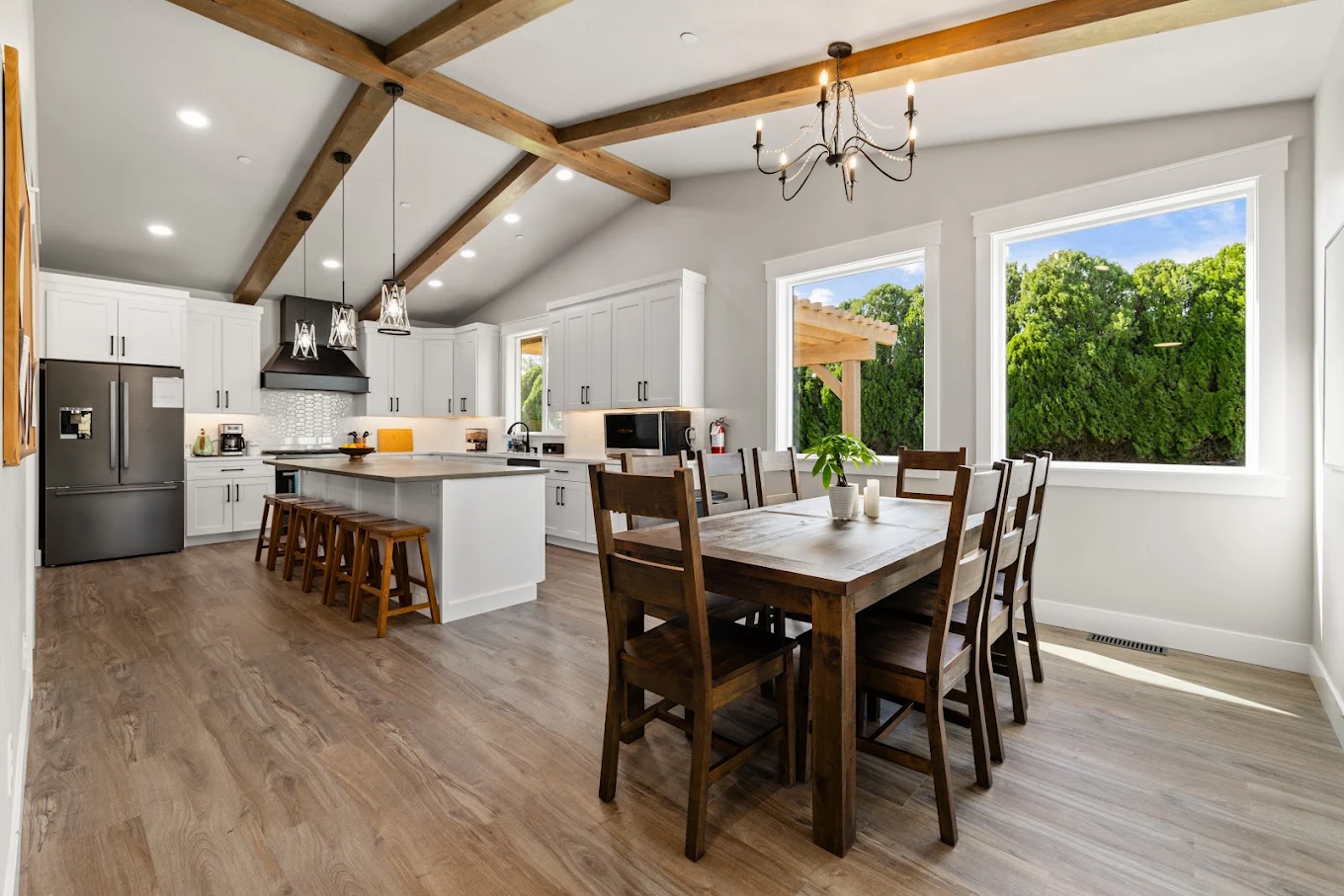 Open kitchen and dining area with island and wooden table