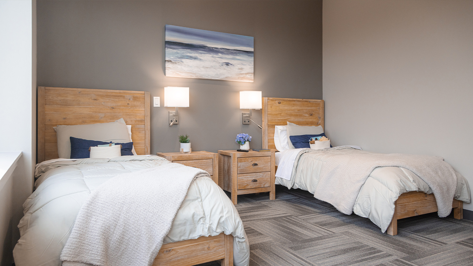 Cozy rehab facility bedroom with twin beds and wooden furniture.