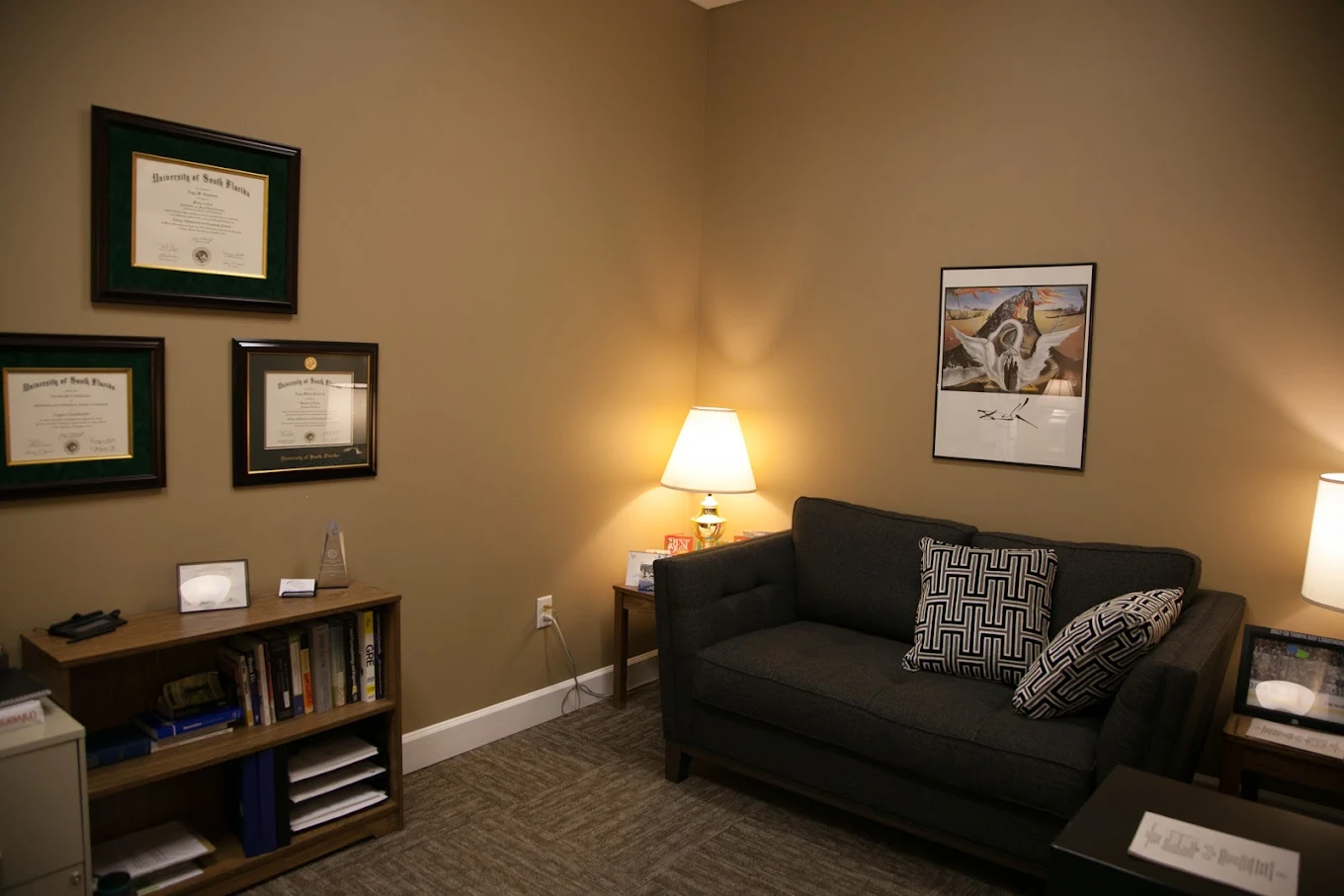 Private therapy room with couch and diplomas