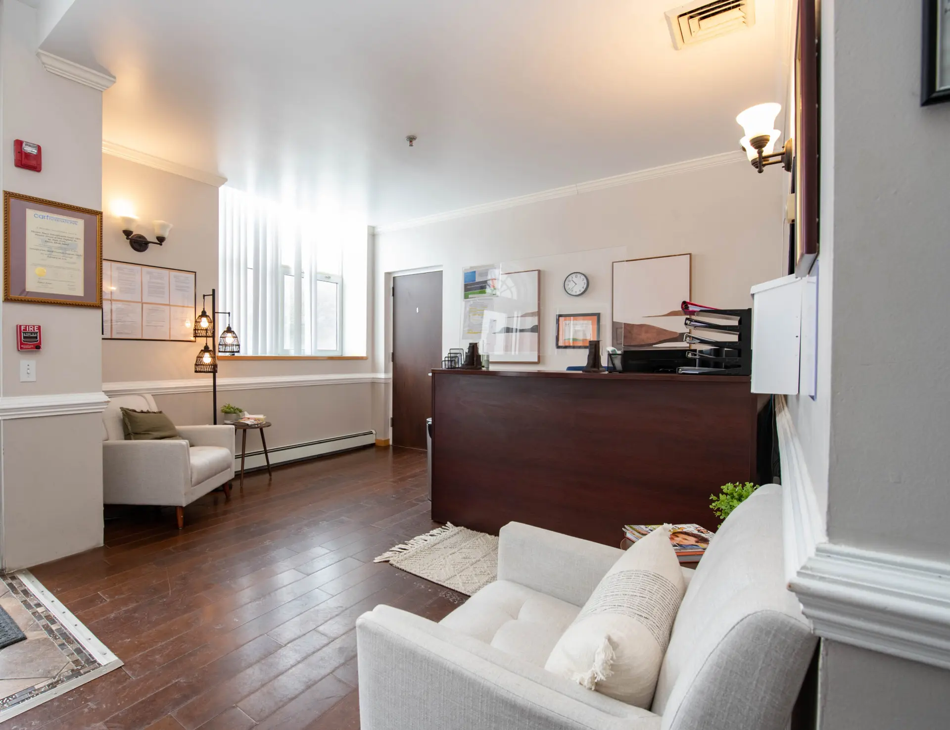 Reception desk with chairs and framed documents