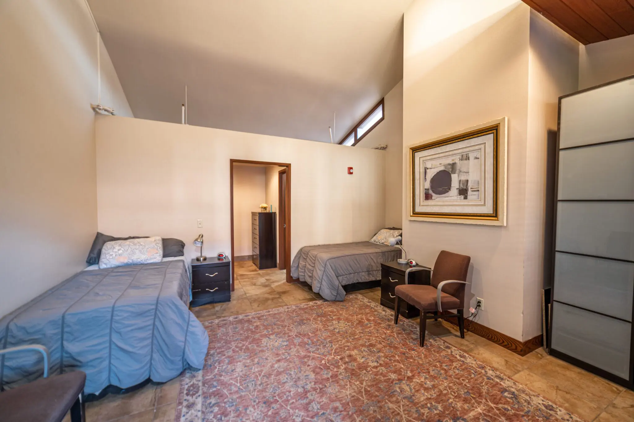 Shared bedroom with two beds and personal storage