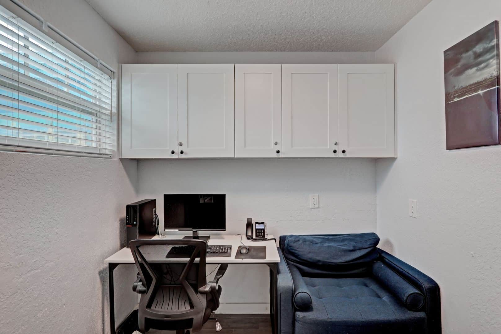 Private therapy room with desk, chair, and computer