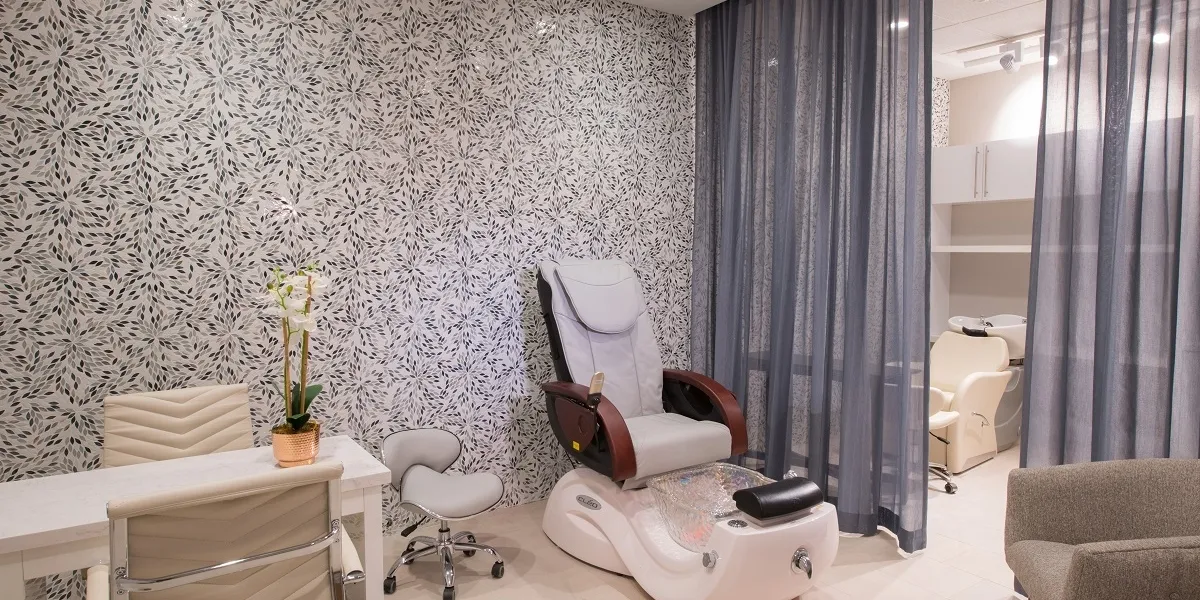 Spa room with pedicure chair and curtained privacy area