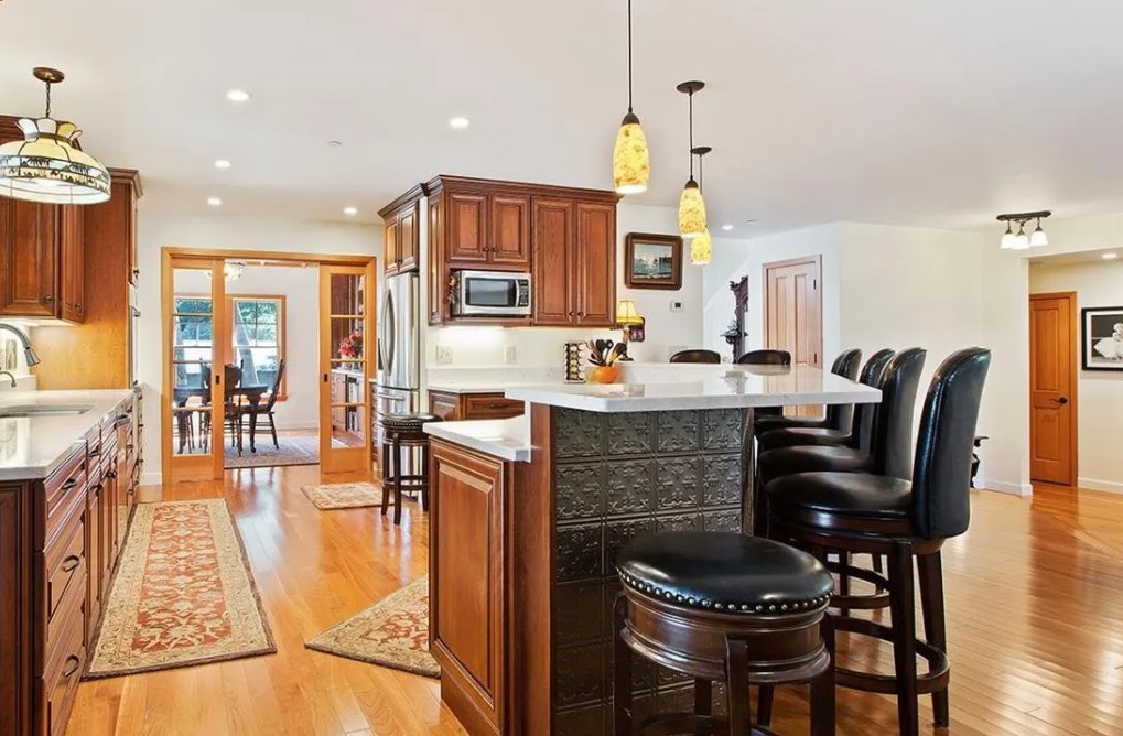 Open kitchen with a large island, and seating,