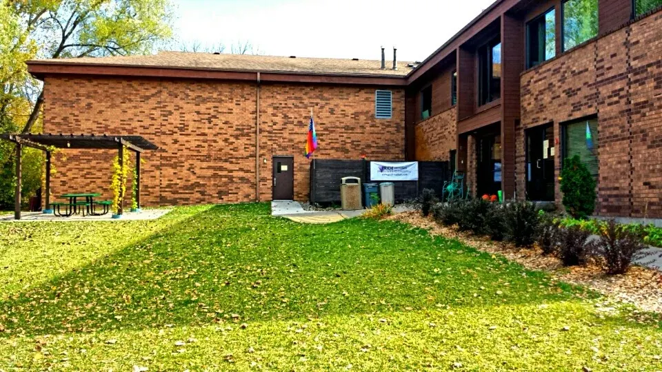 Courtyard with lawn, patio seating, and landscaped grounds