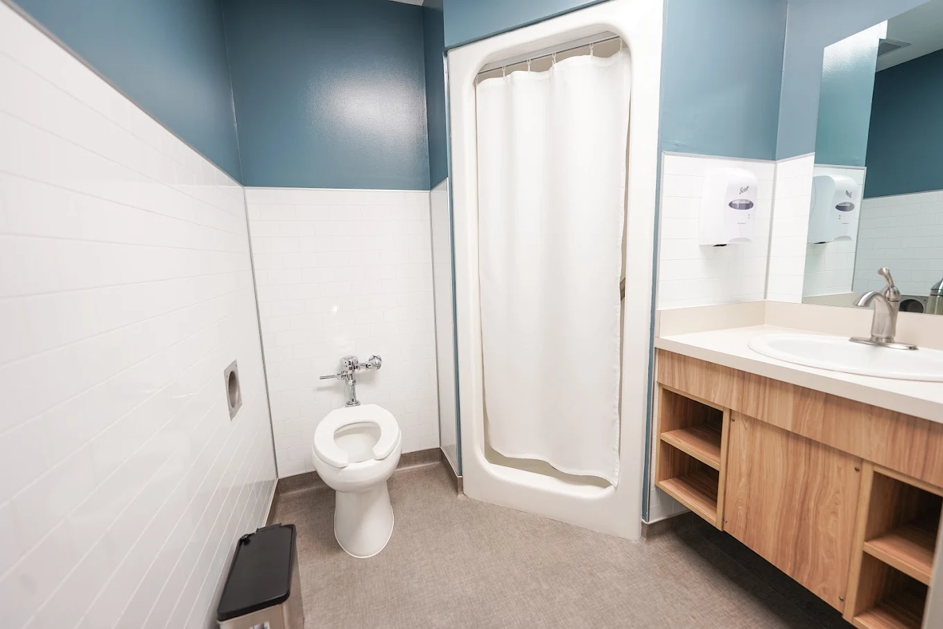 Patient bathroom with shower, sink, and toilet