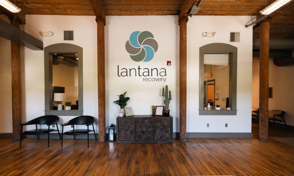 Waiting area with seating beneath Lantana Recovery logo