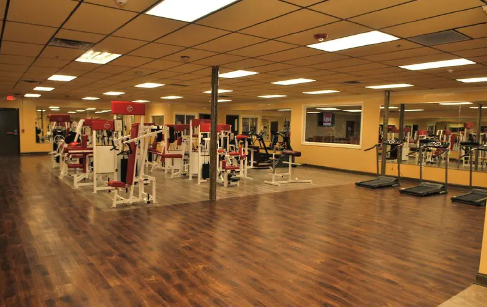A well-equipped gym with various exercise machines and ample floor space.
