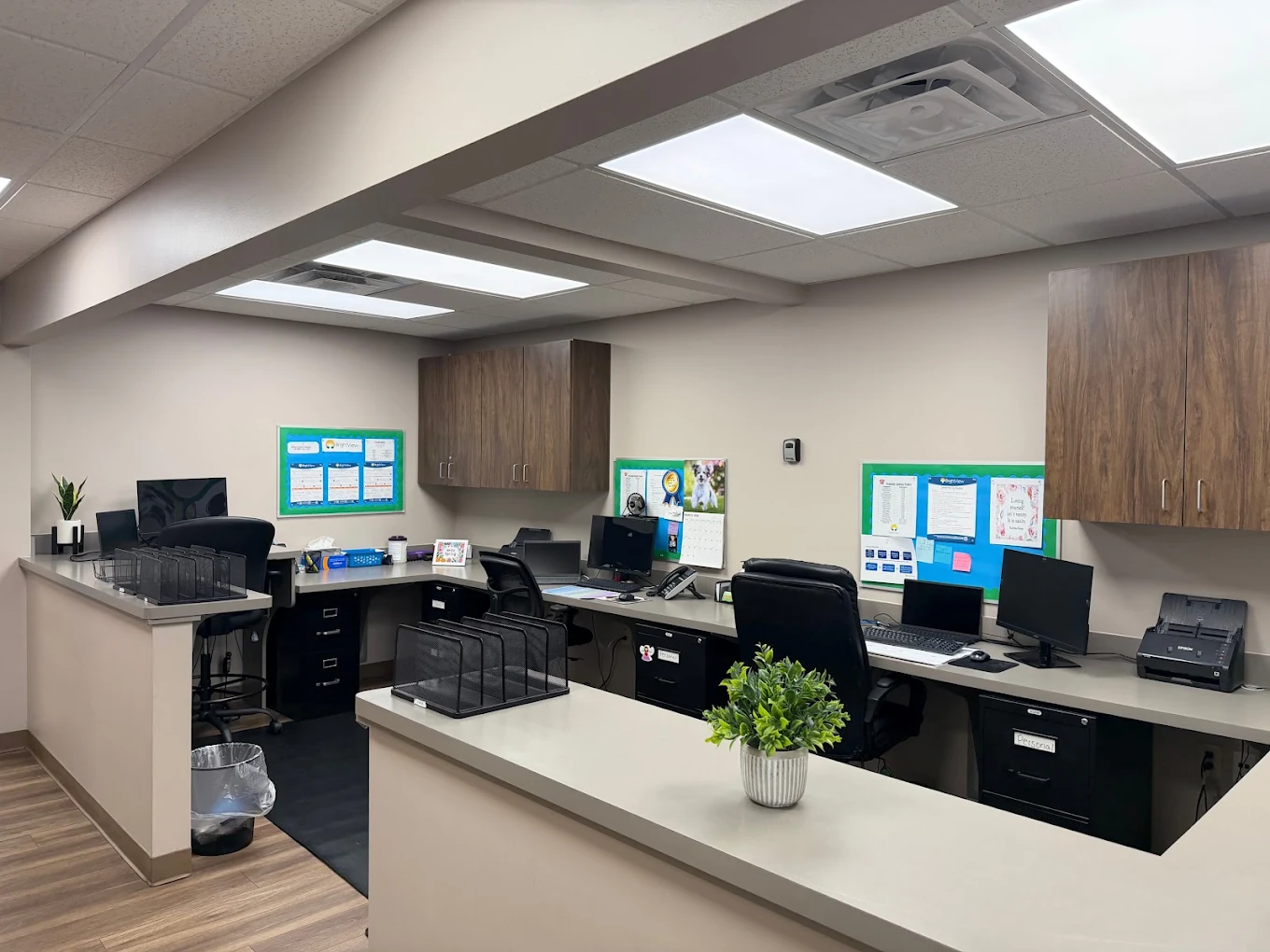 Staff workstation with desks, computers, and cabinets