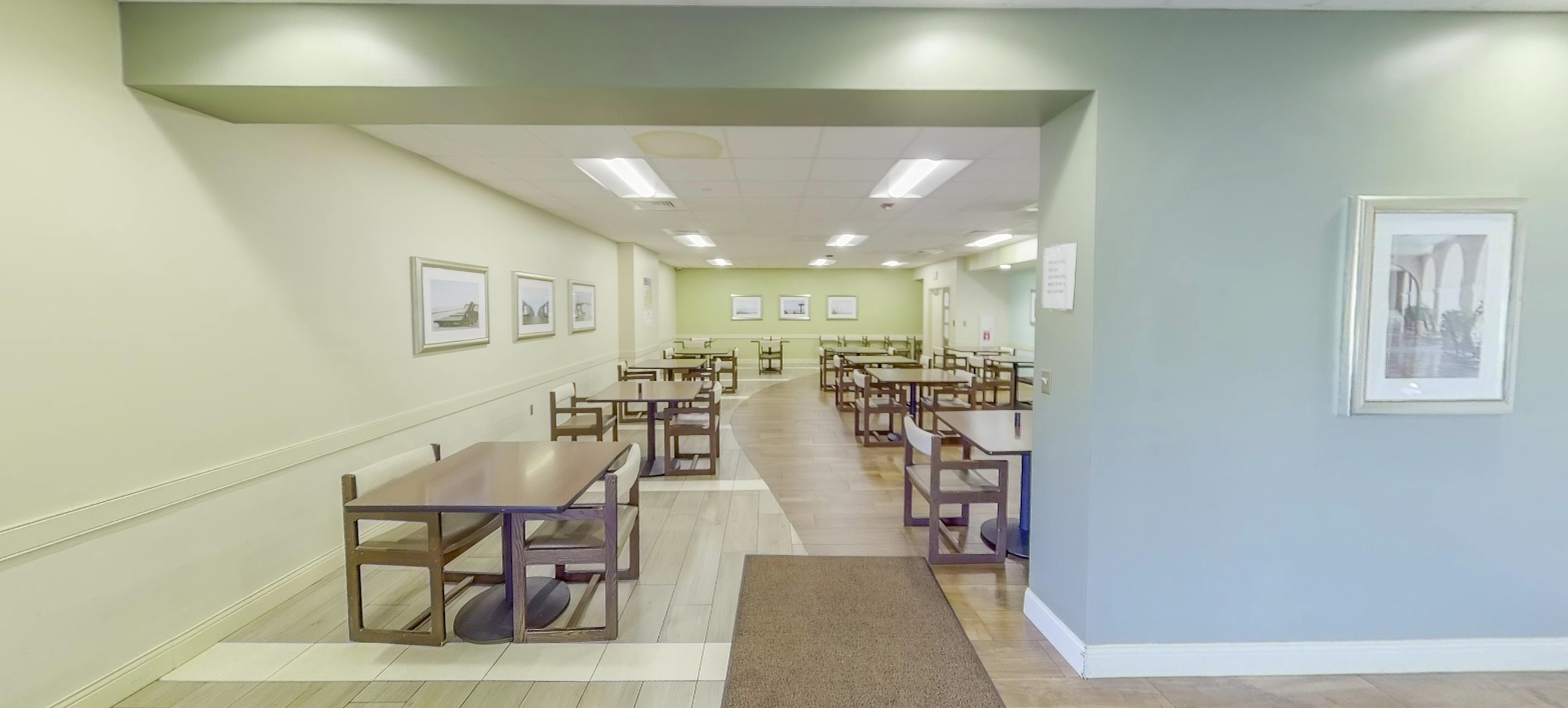 Dining room with tables and chairs for residents