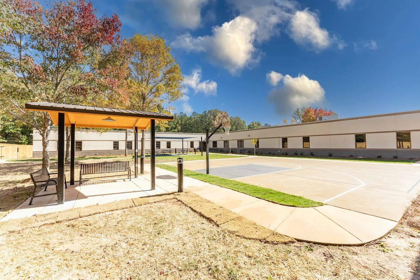 Outdoor basketball court with covered seating area