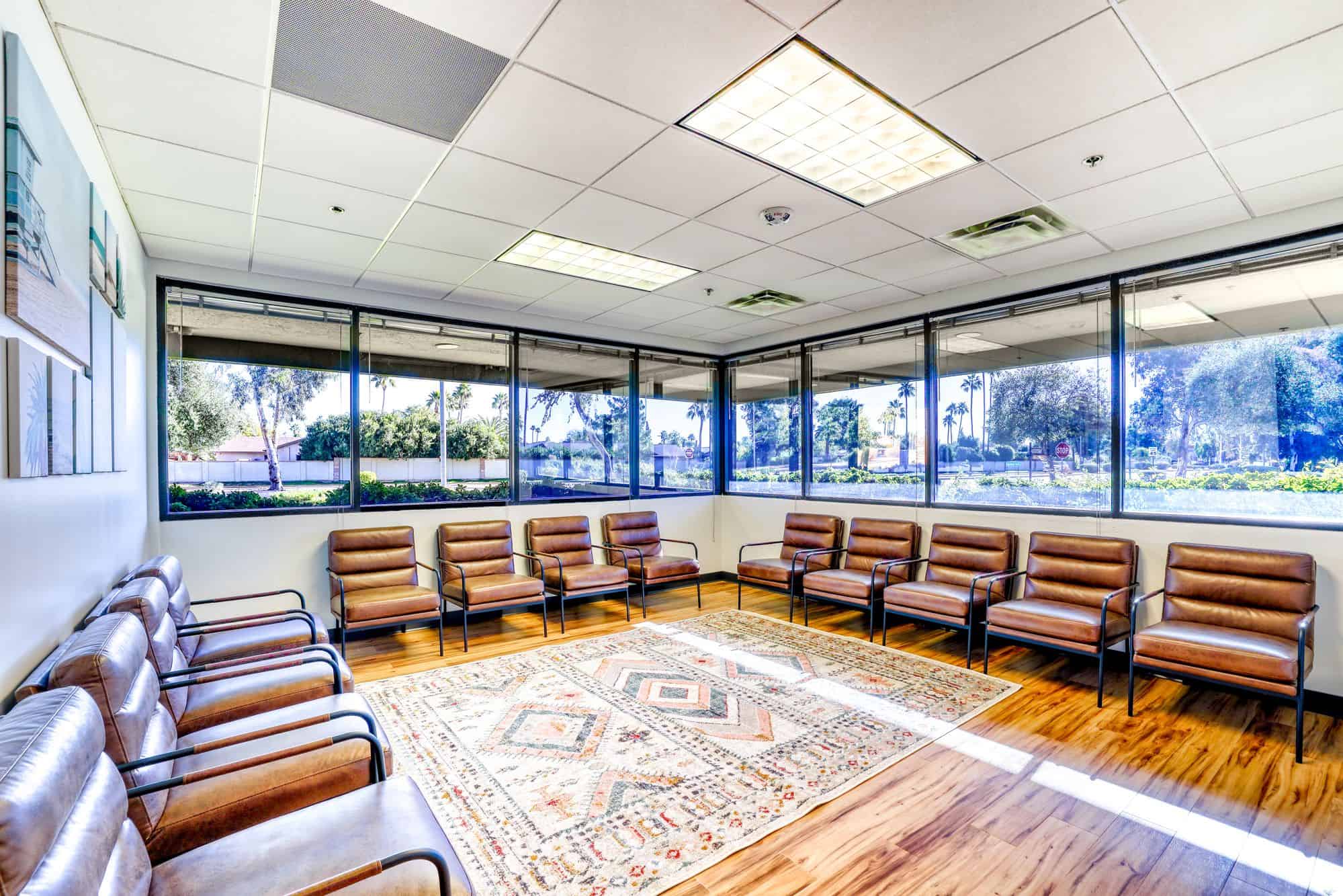 Group room with chairs arranged around patterned rug