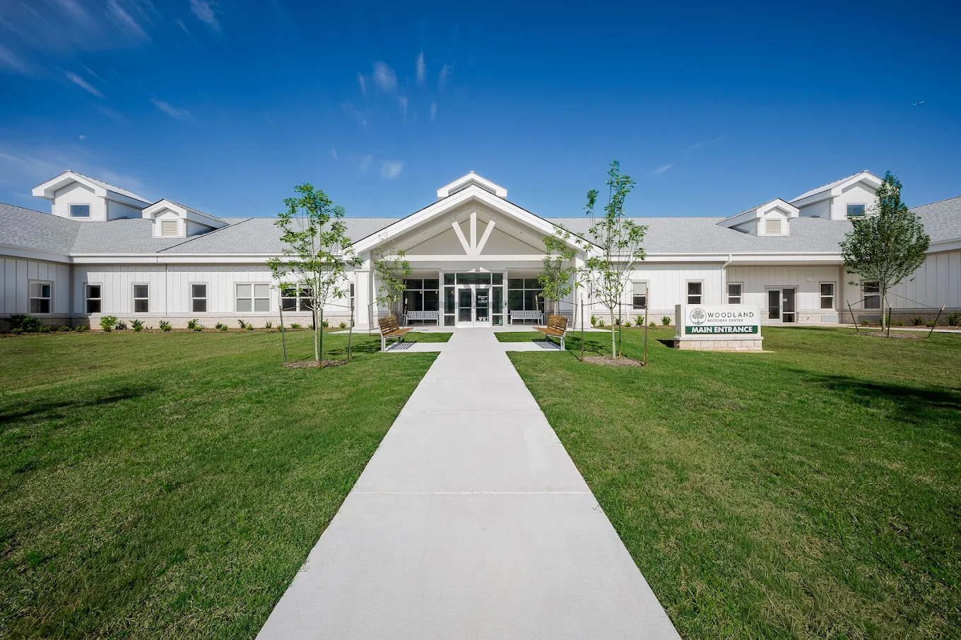 Front exterior of Woodland Recovery Center with a walkway leading to the main entrance