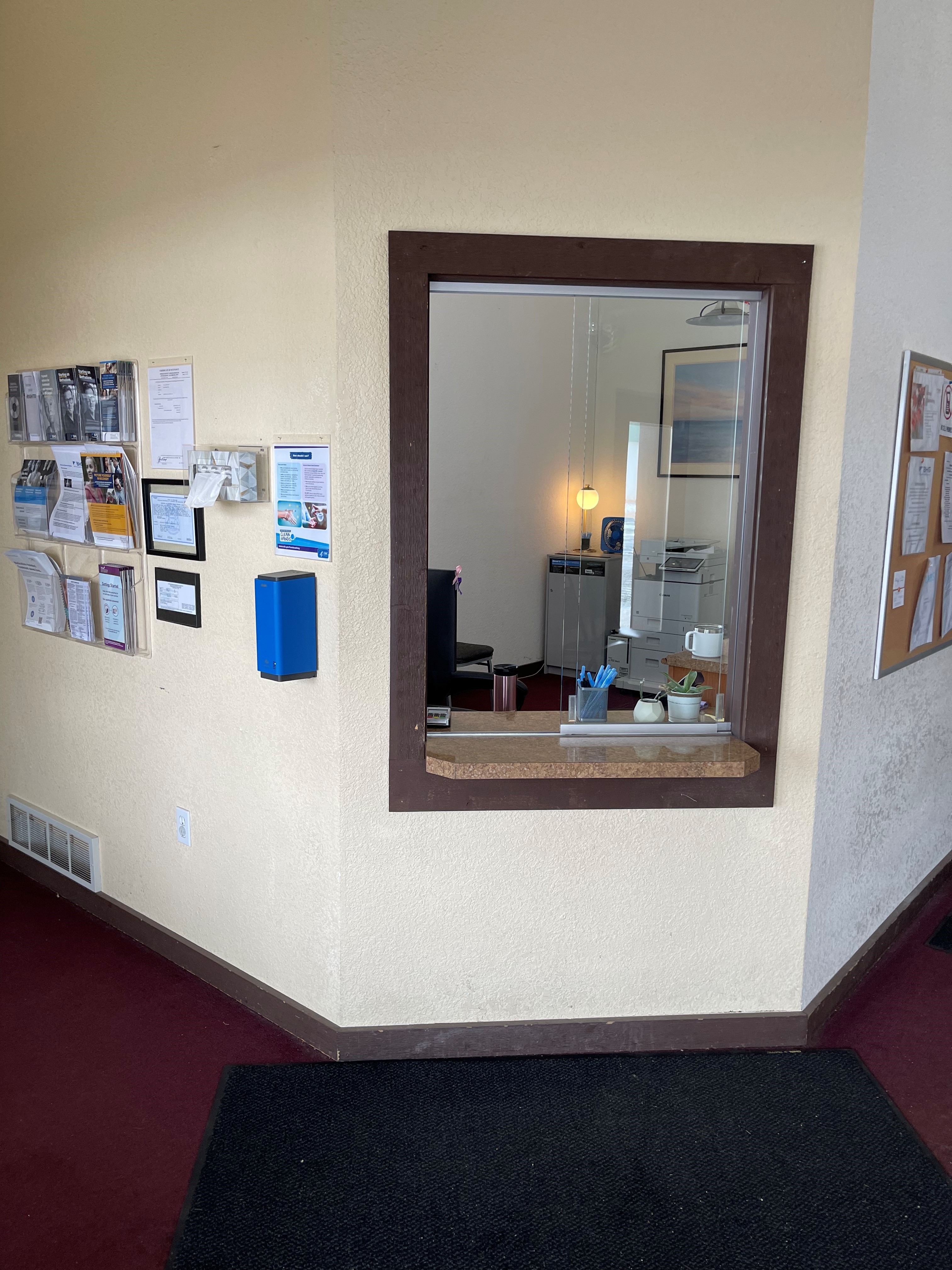 Reception check-in window with patient information display
