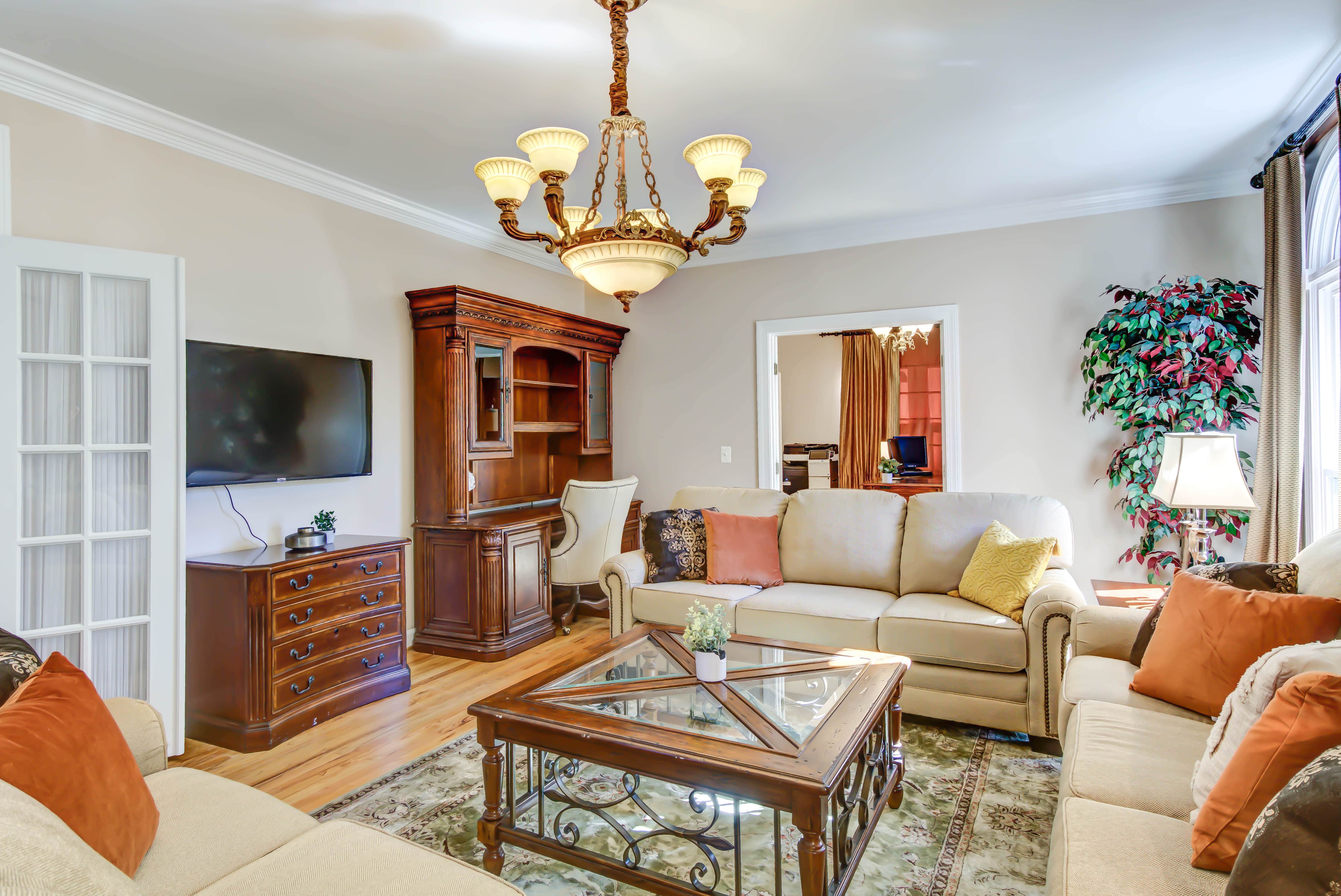  Elegant living room with soft sofas and TV entertainment center