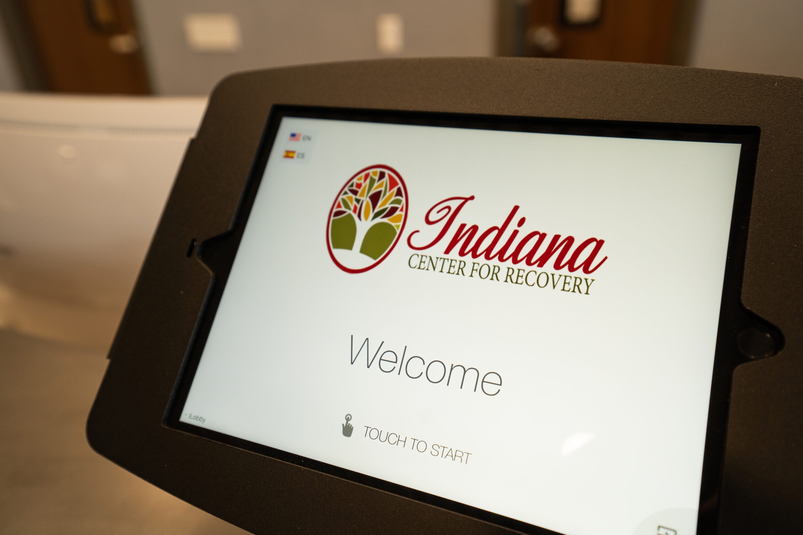 Digital check-in screen displaying facility welcome message.