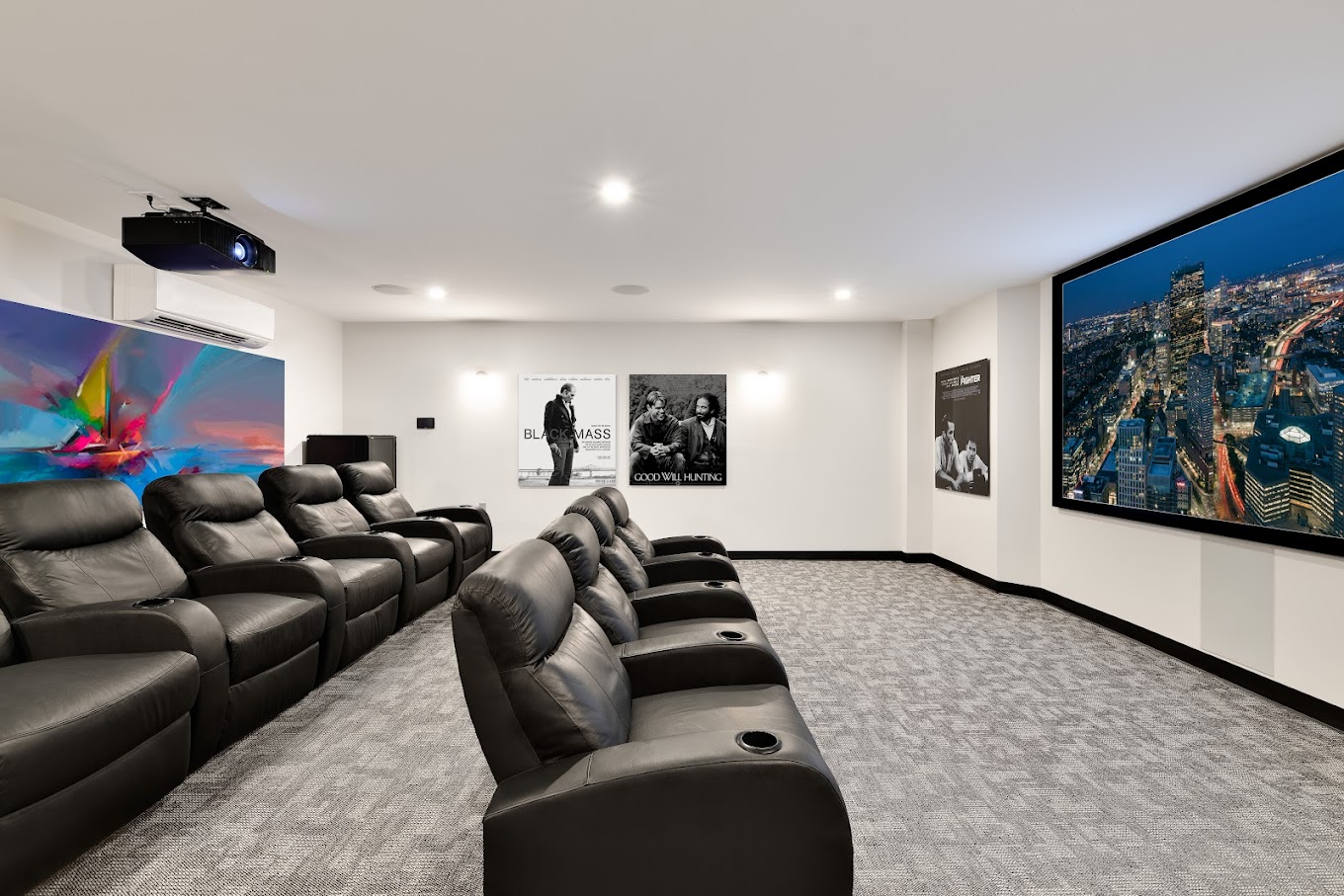 A private theater room with leather recliners.