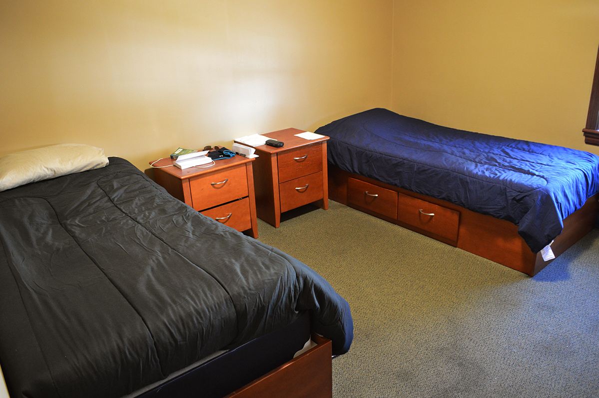 Shared bedroom with two twin beds and nightstands