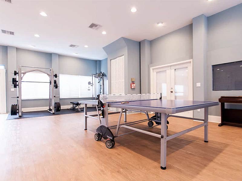 Gym area with weights and ping pong table