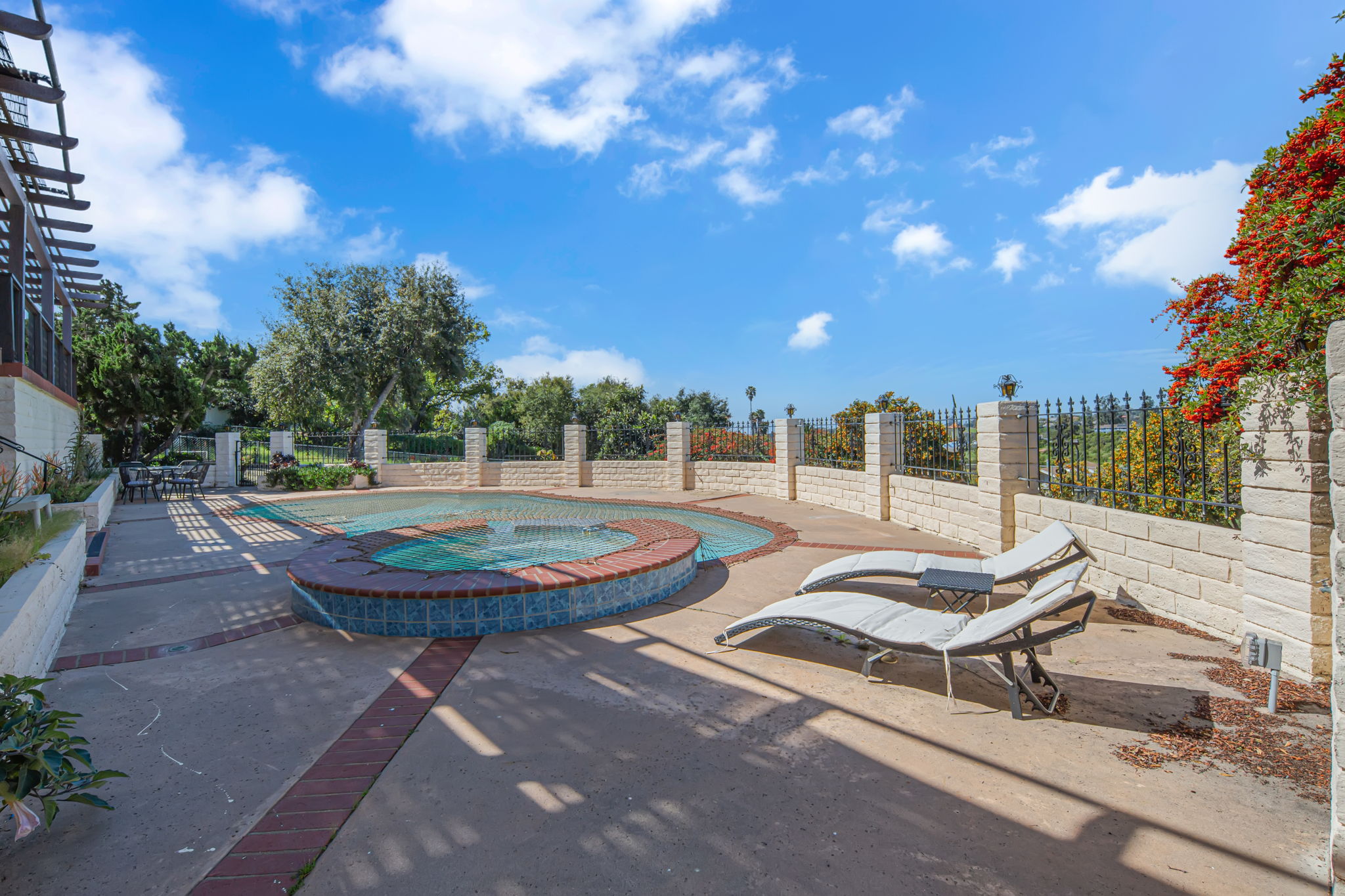 Lounge chairs beside swimming pool and spa