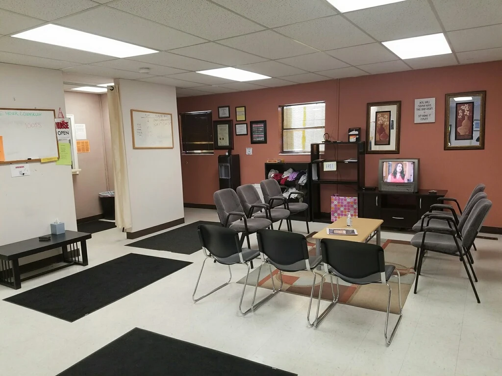 Waiting area with chairs and a TV.