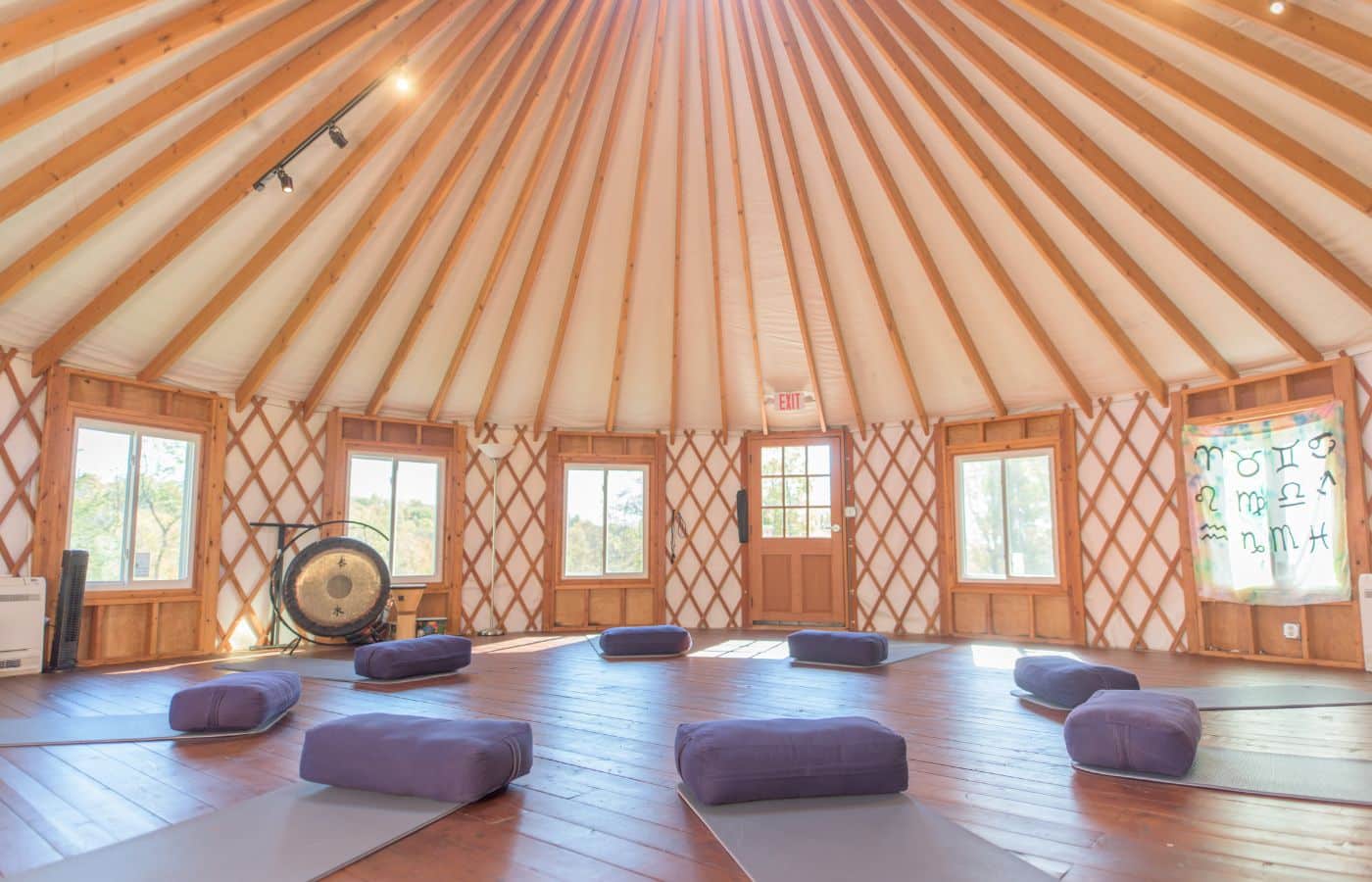Circular yurt with cushions arranged for meditation practice.