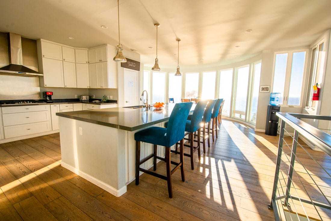 Kitchen with island seating and ocean-facing windows
