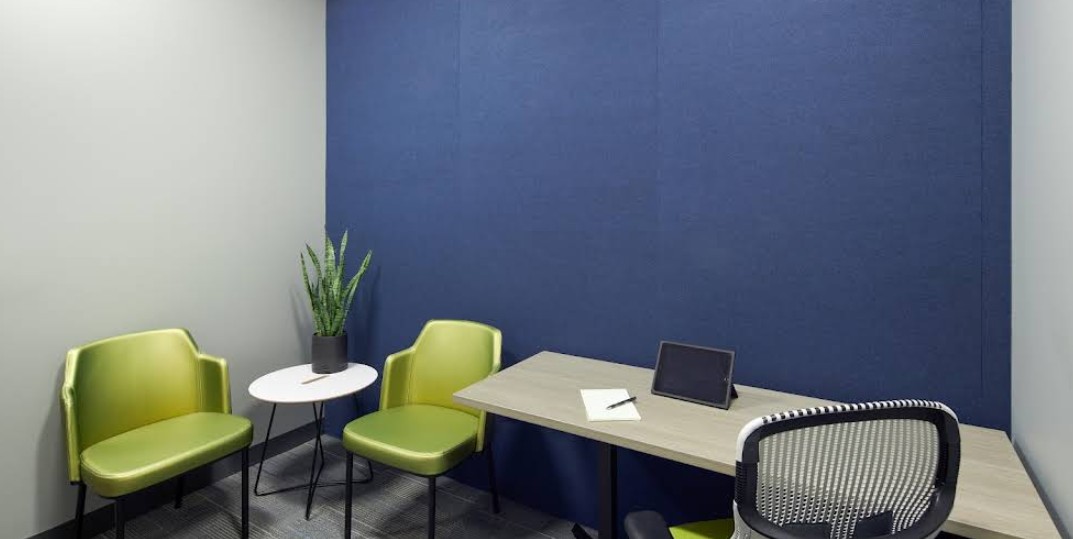 Private counseling office with desk and guest seating