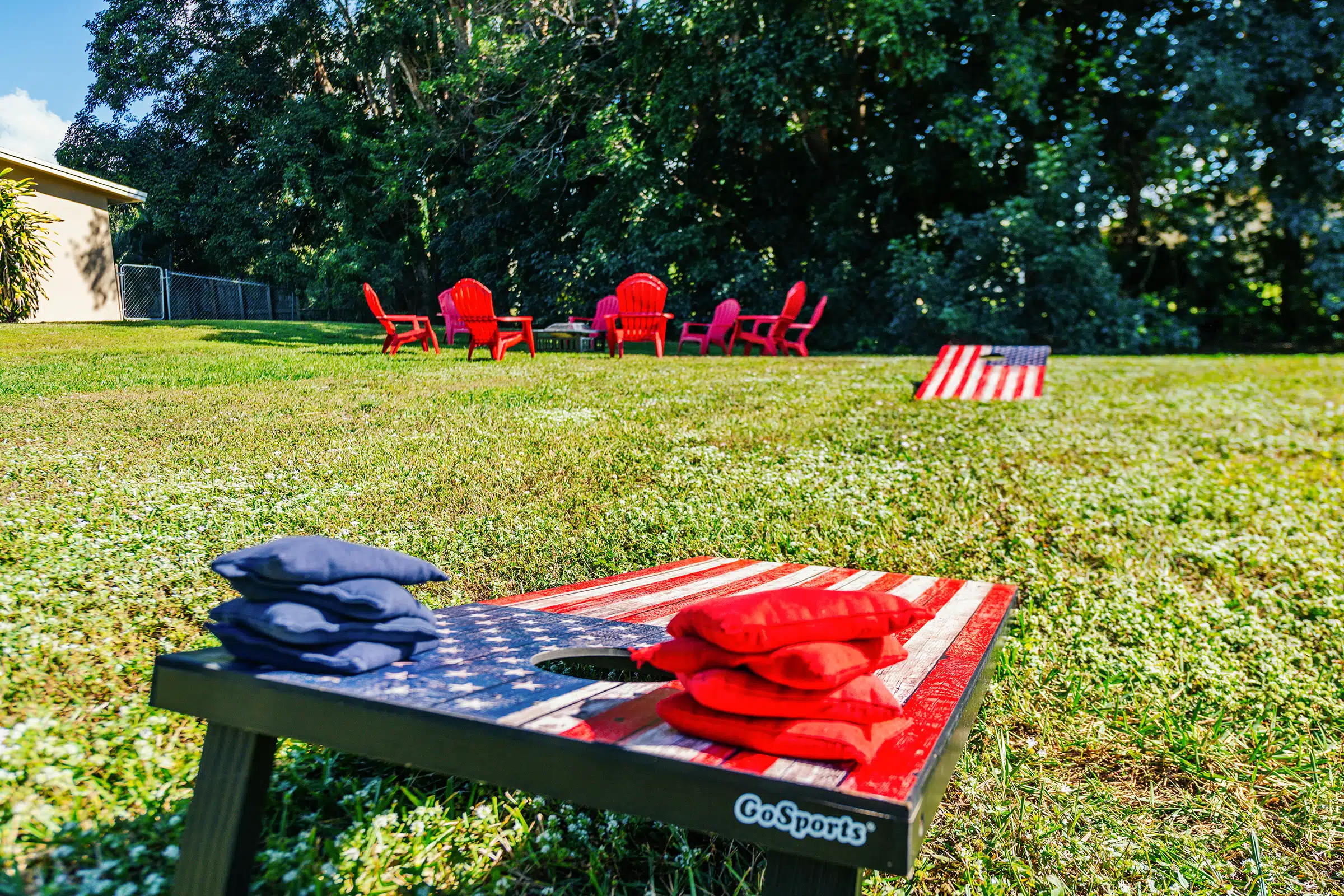Red and blue beanbags on painted cornhole boards