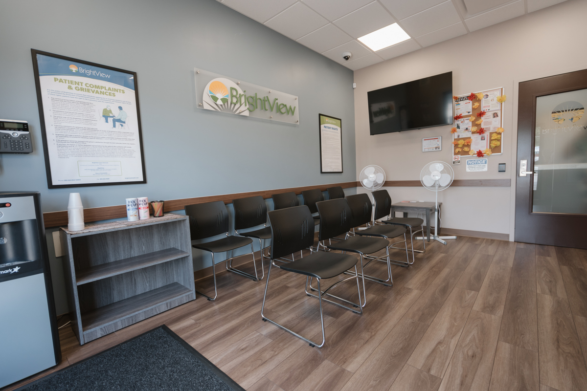 Waiting room with rows of chairs and BrightView wall sign