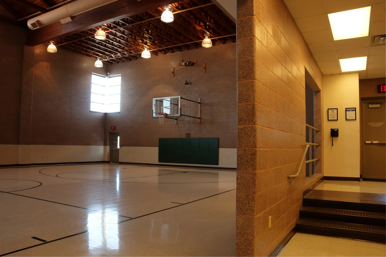 Indoor basketball court with high ceilings and hoop