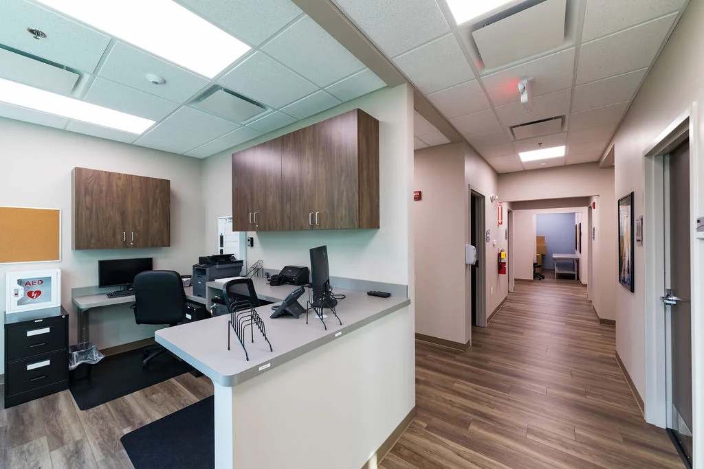 Reception desk with clinical workstations and hallway