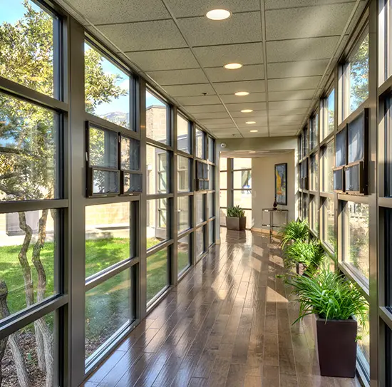 Bright hallway with floor-to-ceiling windows.