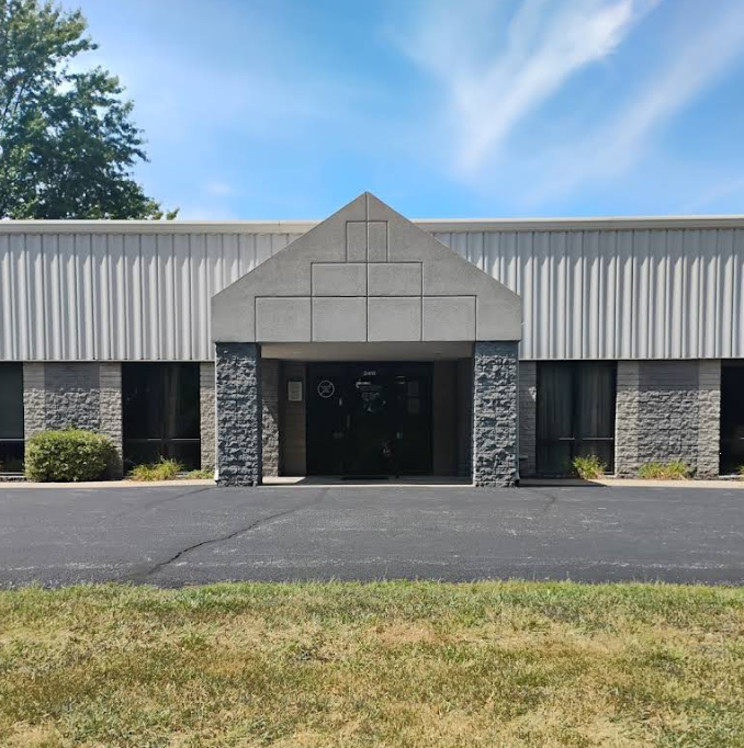 Front view of clinic building with stone pillars and metal siding