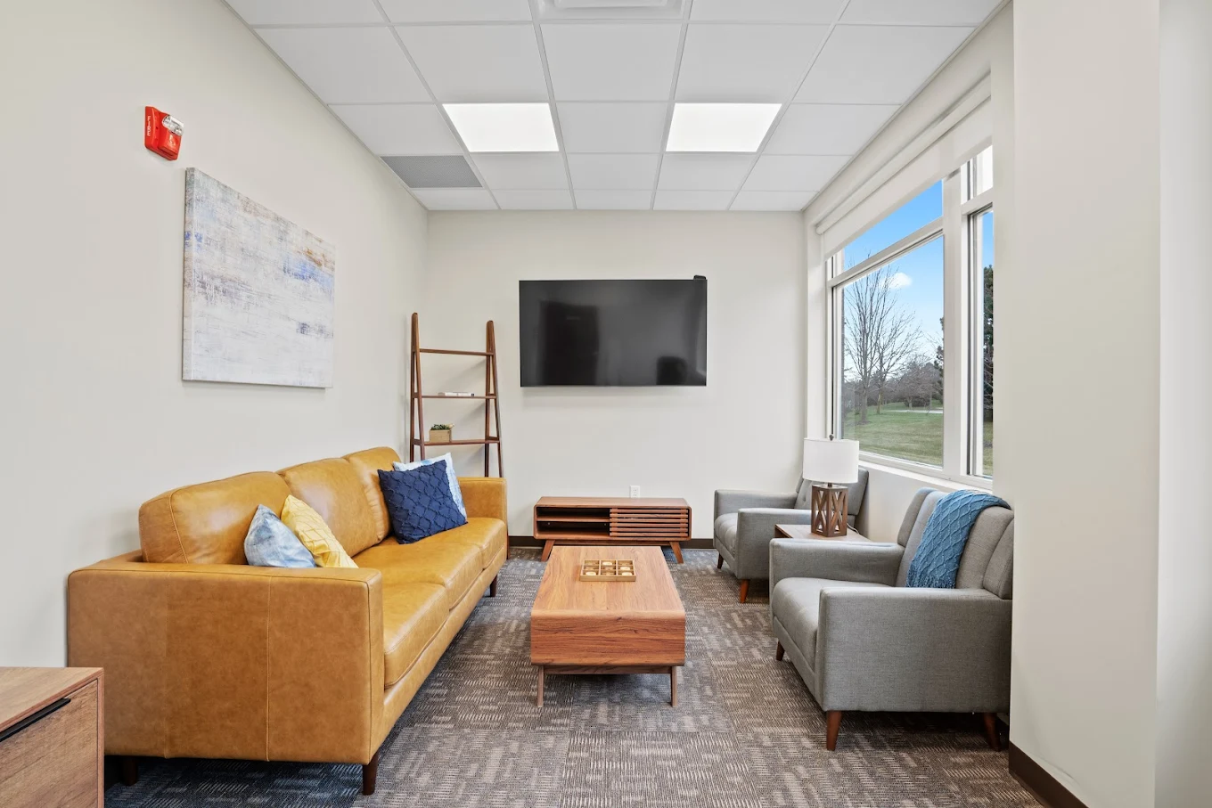 Lounge area with TV and leather sofa
