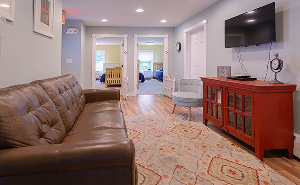 Living room with brown sofa and wall-mounted TV