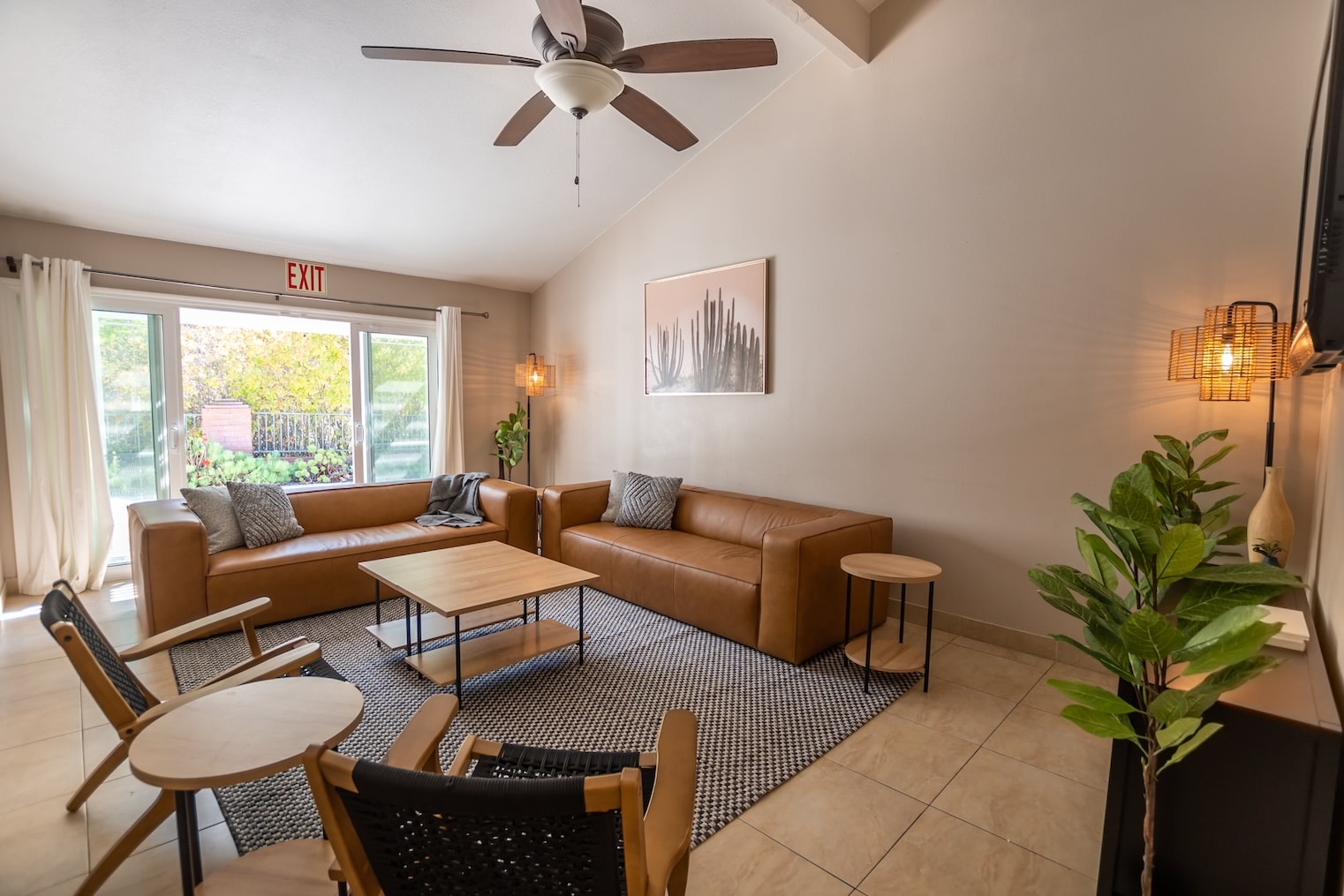 A cozy living area with leather sofas and wooden furniture.