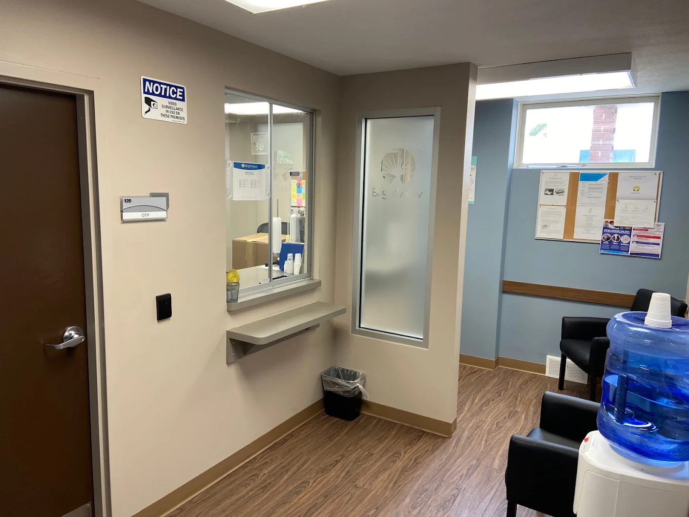 Reception area with TV, refreshment station, and seating