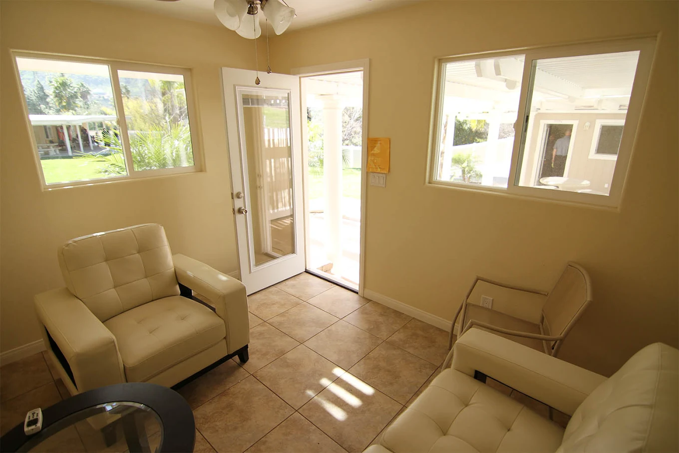 Bright lounge with cushioned chairs and views of outdoor area.