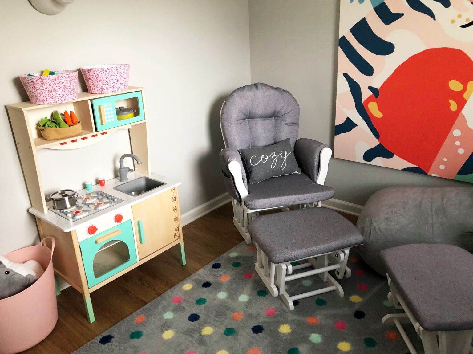 Children’s play corner with toy kitchen and cushioned chair